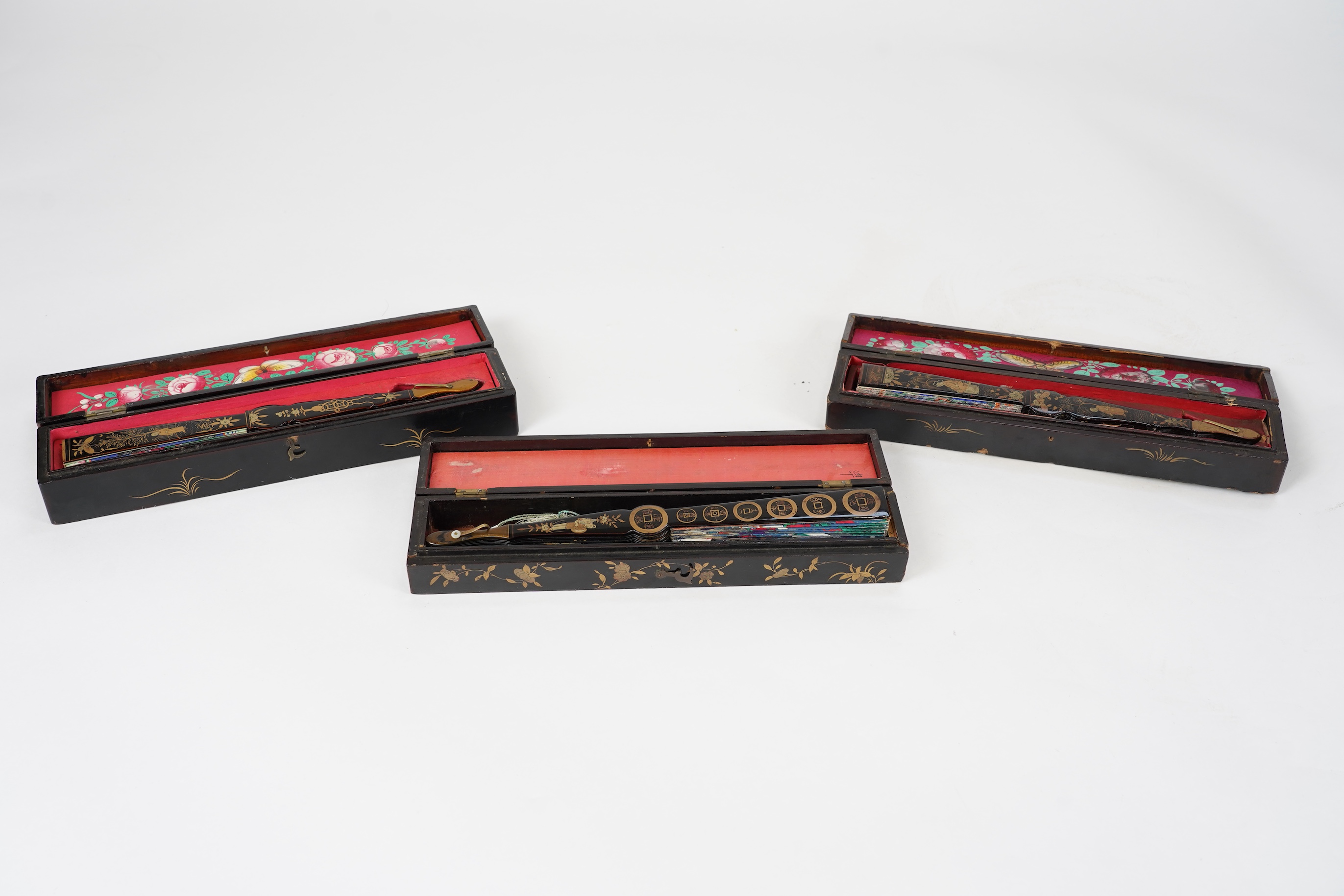Three Chinese gilt-decorated black lacquer and painted leaf fans, 19th century